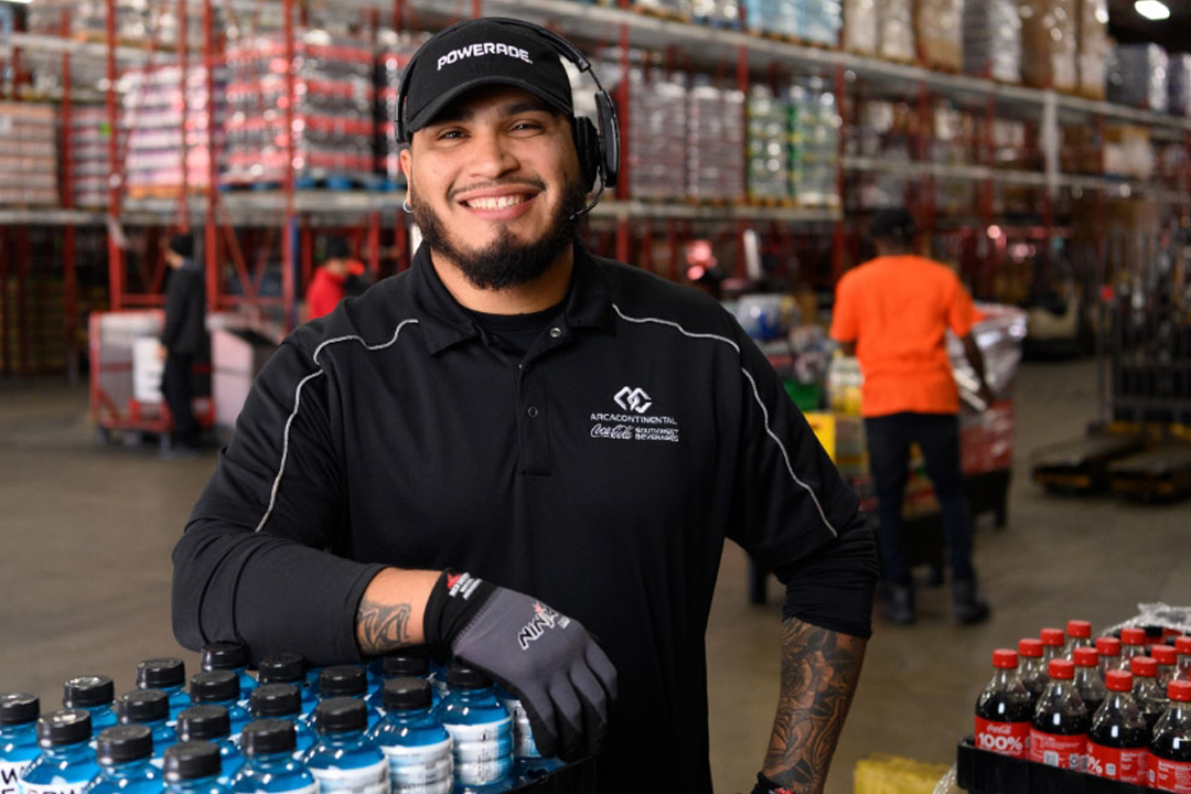 Man in warehouse with Coca-Cola products