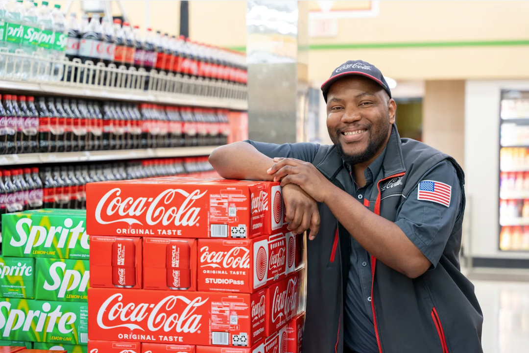 Man in grocery store aisle with Coca-Cola and Sprite products