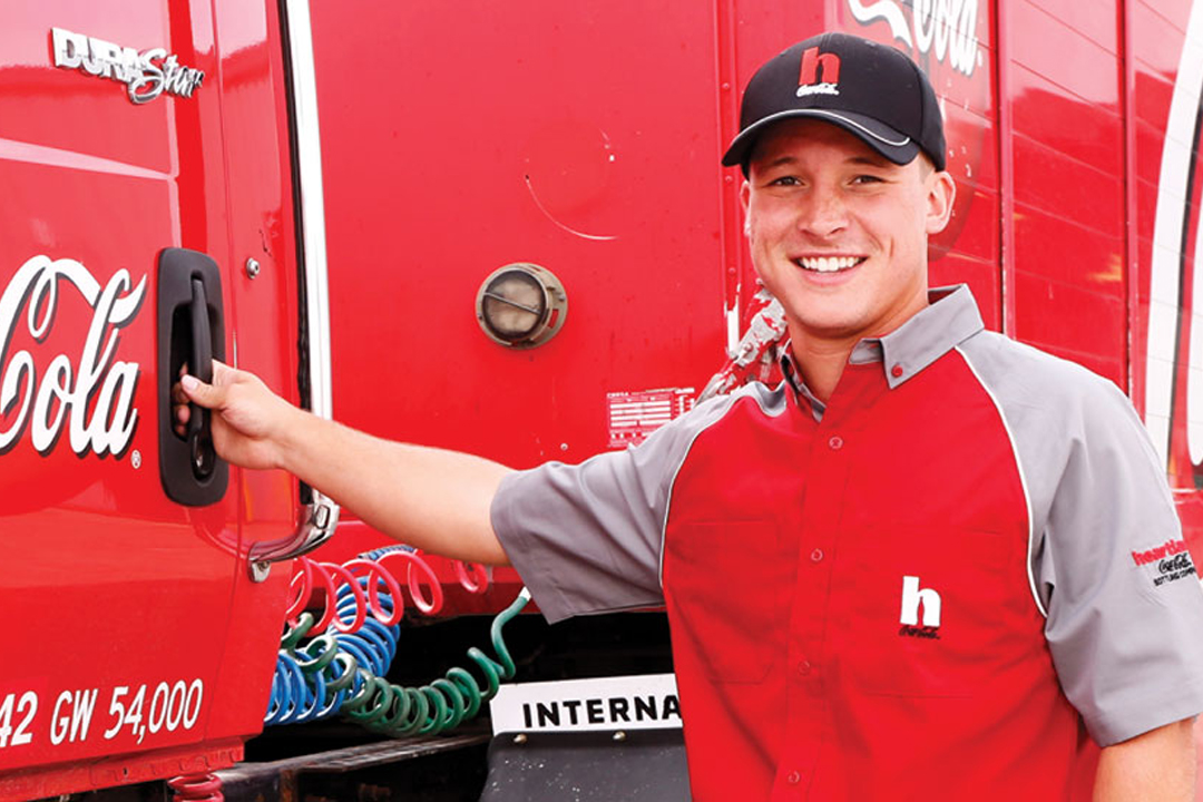 Man next to a Coca-Cola semi-trailer truck
