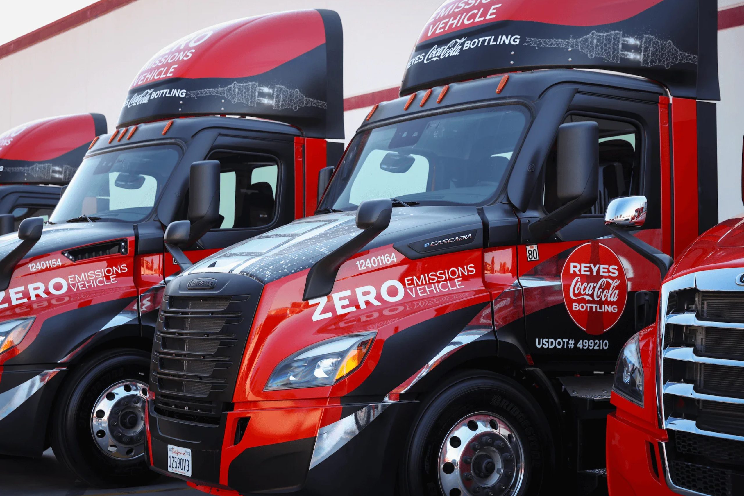 Lineup of Reyes Coca-Cola semi-trailer truck cabs